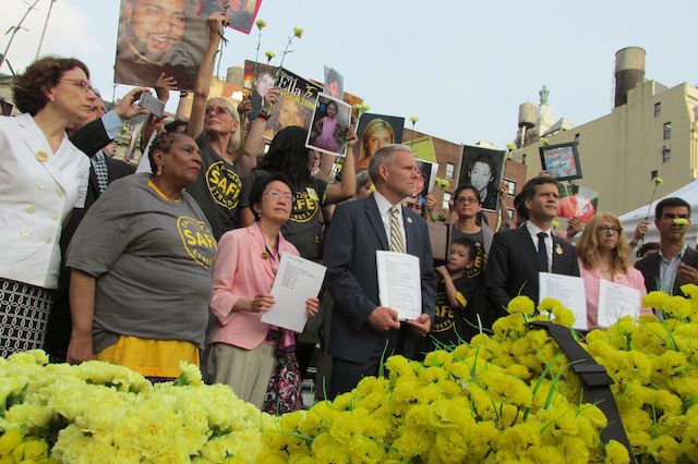 Victims of traffic crashes, and family members of those who have been killed in NYC traffic, standing with elected officials at a rally